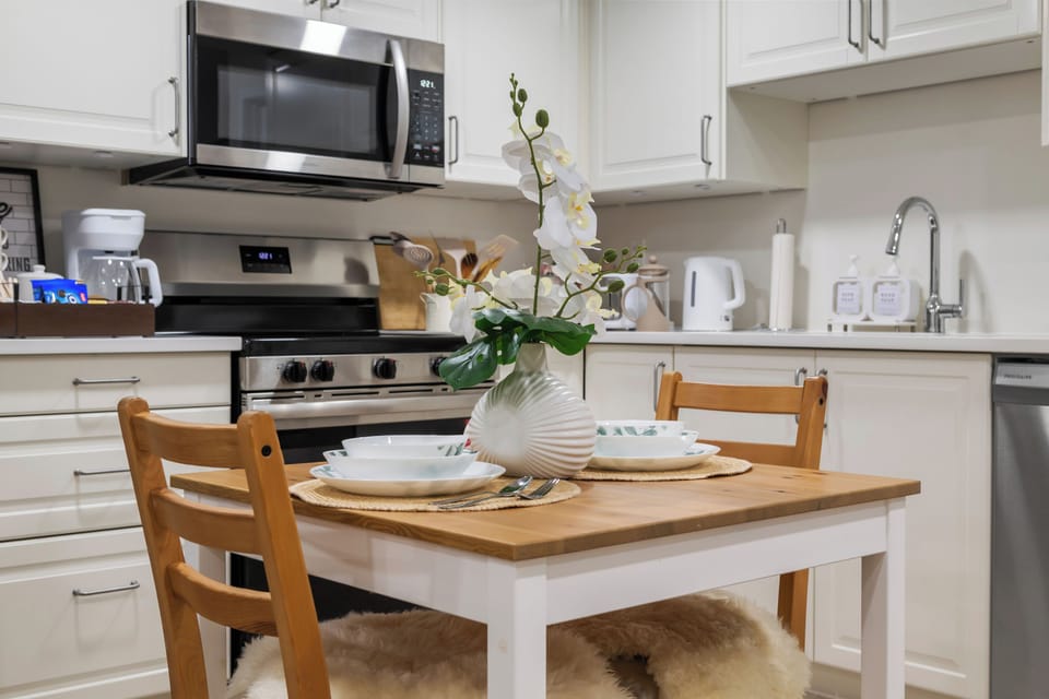 Fully equipped kitchen with stainless appliances and cozy dining nook