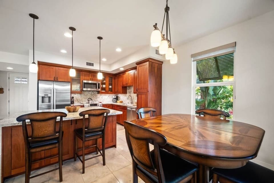 Kitchen and dining area with island seating and garden views