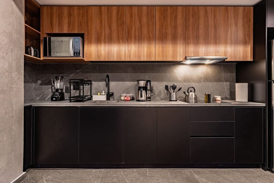 Prepare meals with ease in the sleek kitchen featuring modern appliances.