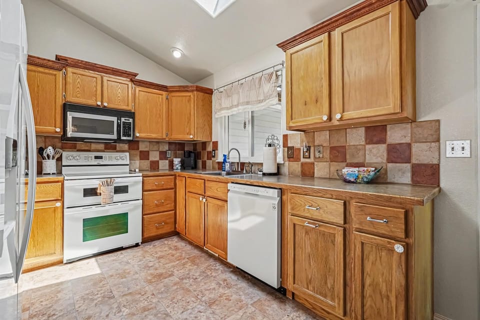 It is fully stocked with everything you need to prepare a delicious home-cooked meal, including essential cookware, dishes, and appliances. This kitchen makes cooking enjoyable and provides the perfect space to gather, share meals, and create memories.