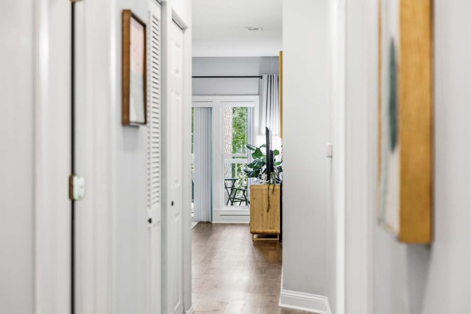 A short hallway leads from the sleeping areas directly into the open-concept main living space.