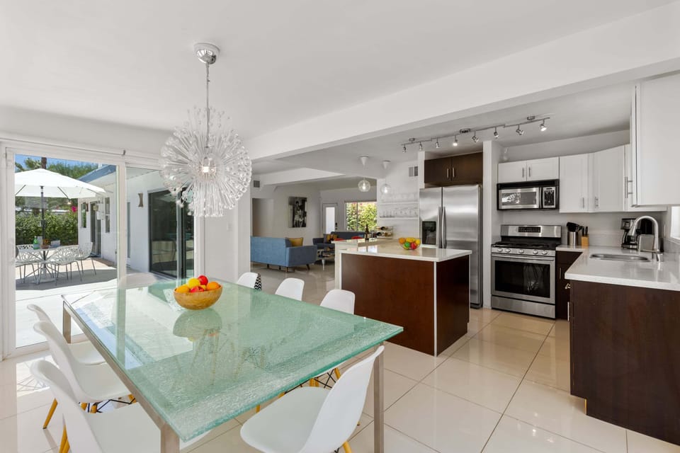 Dining area adjacent to the kitchen has a large table and seating for up to 8 guests.