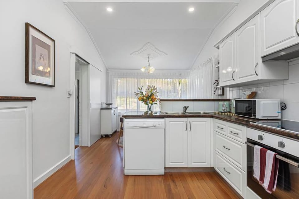 A fully stocked, sunlit kitchen ready for you to prepare home-cooked meals during your stay.