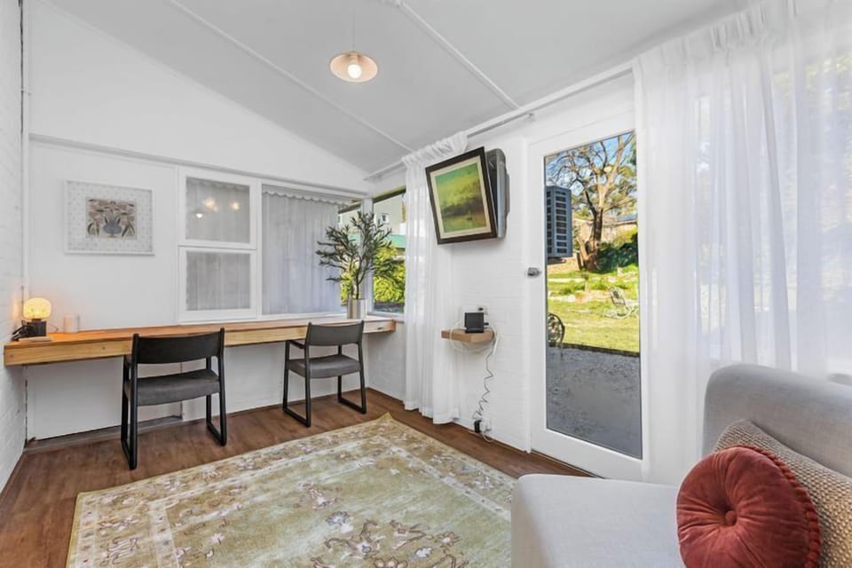 Bright workspace and sitting area with garden views.