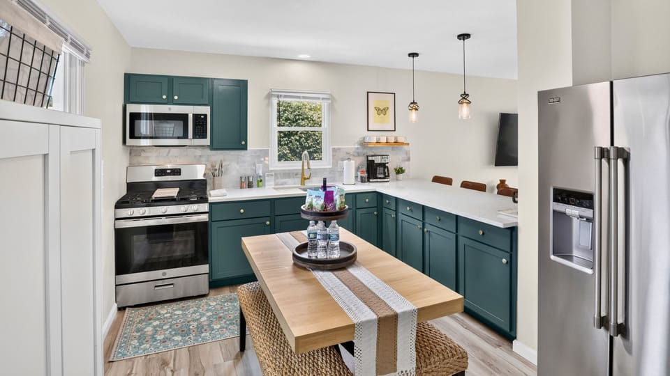 Fully stocked eat in kitchen with additional bar stool seating and gas range.