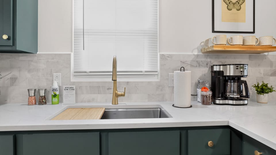Oversized sink and coffee station with drip, pods, tea, and essentials.