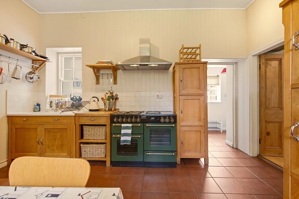 Spacious farmhouse kitchen with classic range cooker and solid oak cabinetry