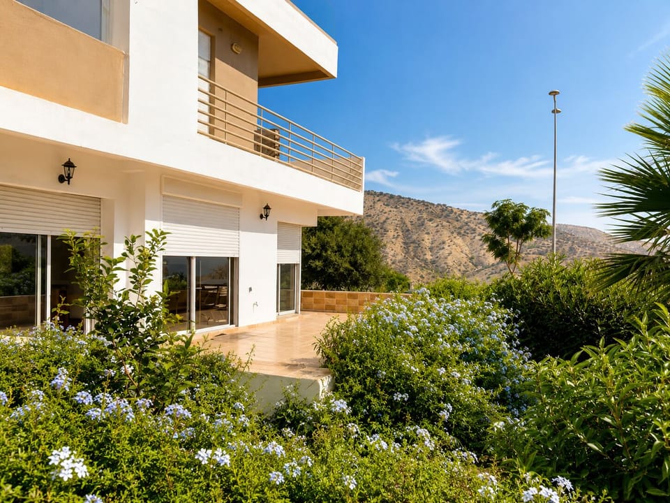 Modern hillside villa with sunny terrace, balcony, and mountain views