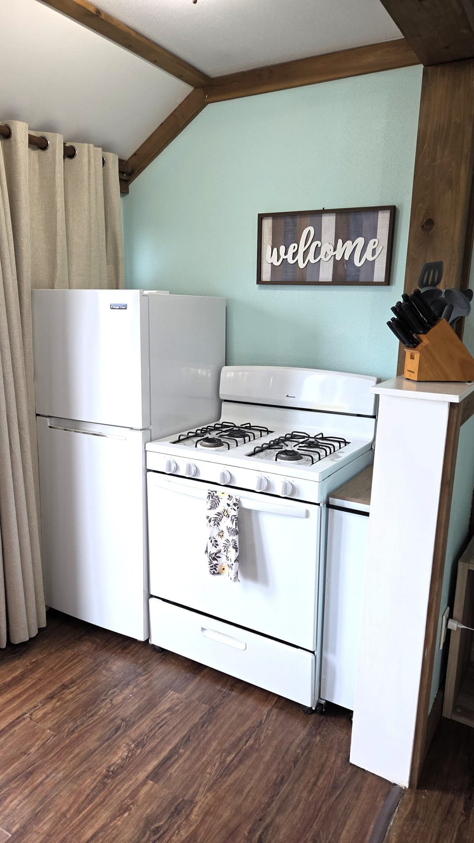 The kitchen has a gas range and full-size refrigerator