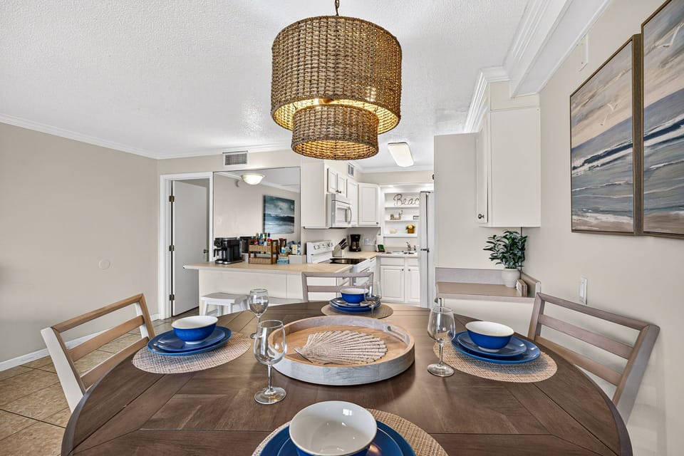 Bright open dining space with coastal style and a fully equipped kitchen