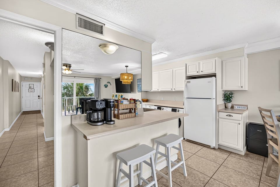 Bright open kitchen with breakfast bar and easy flow to the balcony