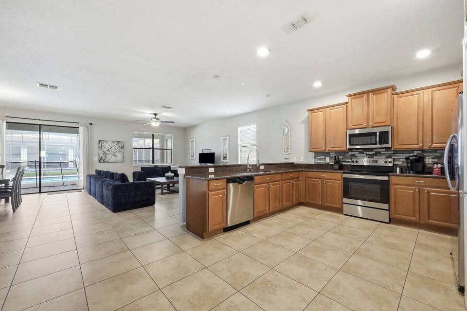 Spacious open kitchen and living area with pool views