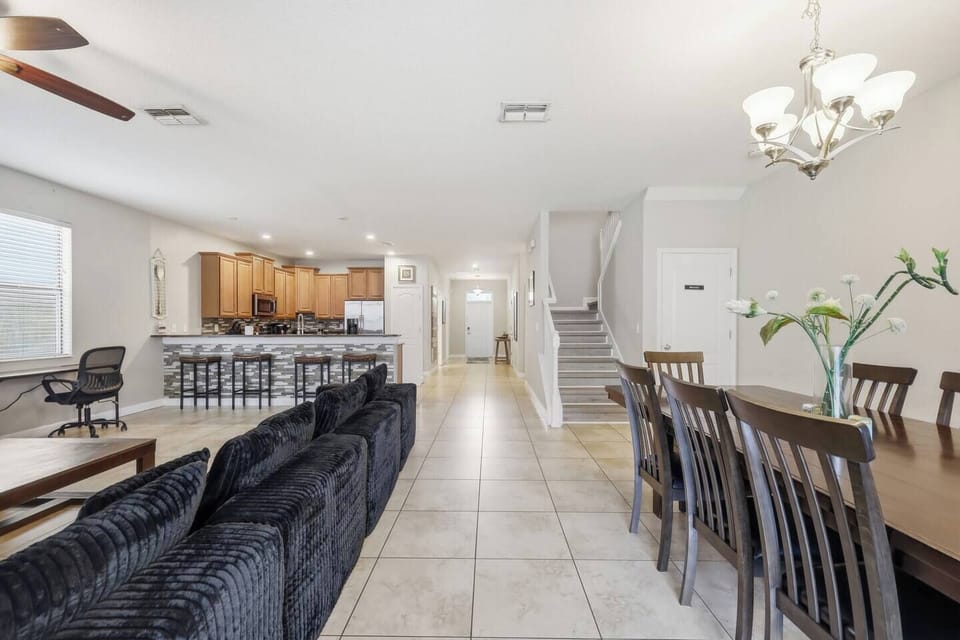 Bright open-concept living with breakfast bar, dining area, and workspace