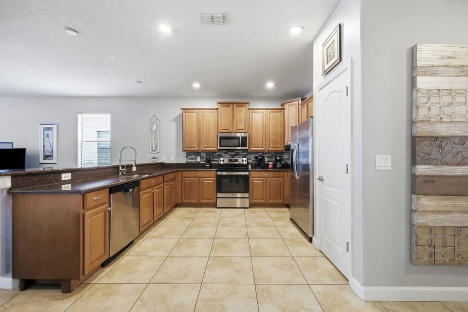 Spacious open kitchen with stainless appliances and breakfast bar