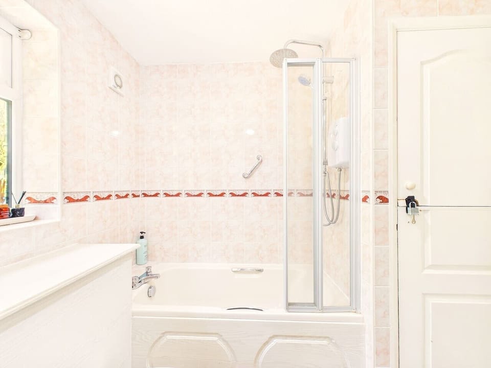 Bright bathroom with both a bathtub and separate shower for your comfort.