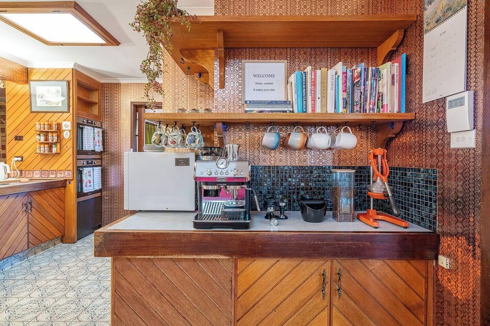 Start your day at the coffee station, where an espresso machine and thoughtfully arranged essentials make your morning ritual effortless.