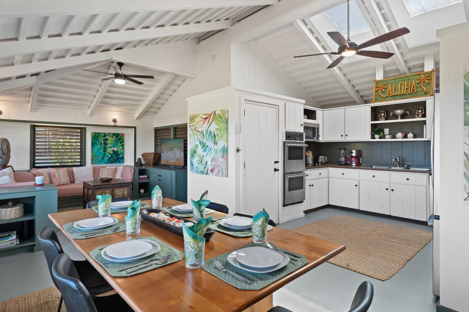 Open-concept kitchen and dining area with vaulted ceilings, modern appliances, and plenty of space for gathering.