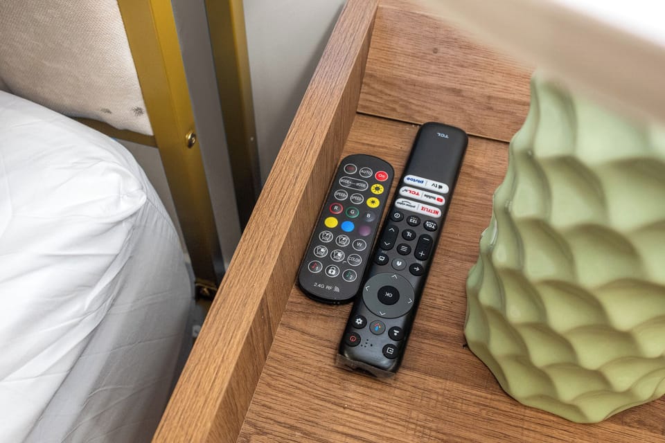 TV remotes are conveniently placed within easy reach of the bed.