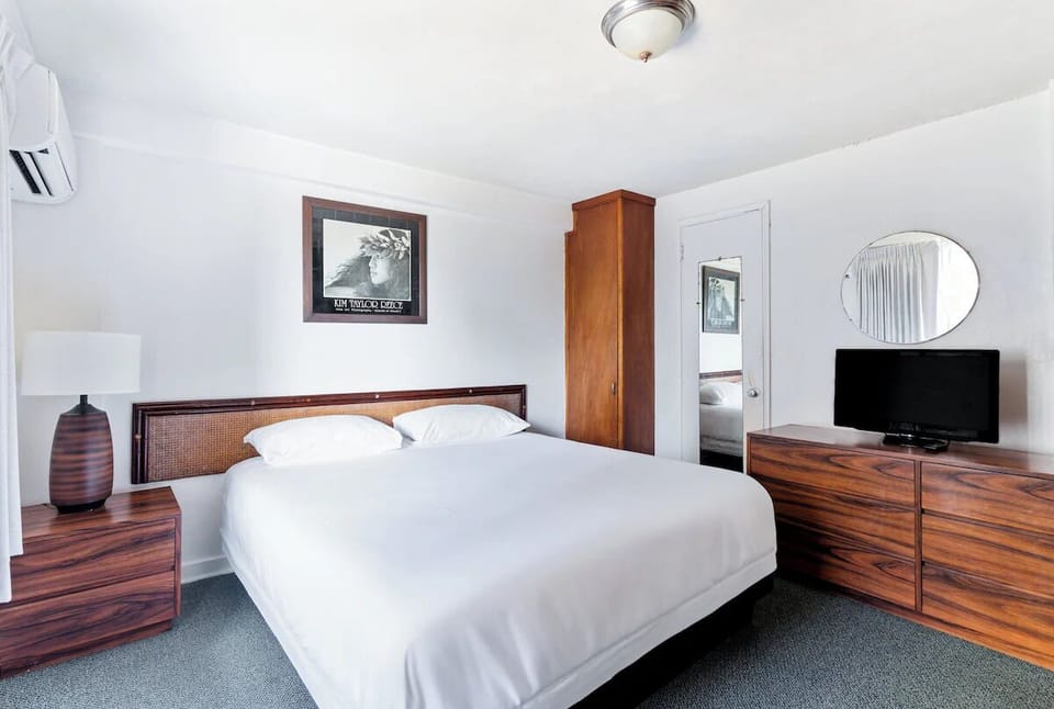 Sink into crisp linens in this calm, spacious bedroom.
