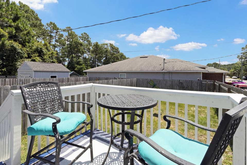 Relax on the private back deck, offering comfortable bistro seating and clear views of the fully fenced backyard.