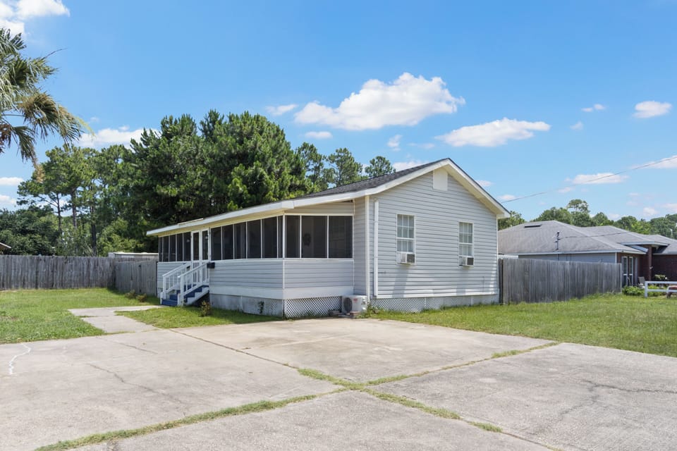 The property offers a wide, expansive concrete driveway with ample space for convenient guest parking right outside the unit.
