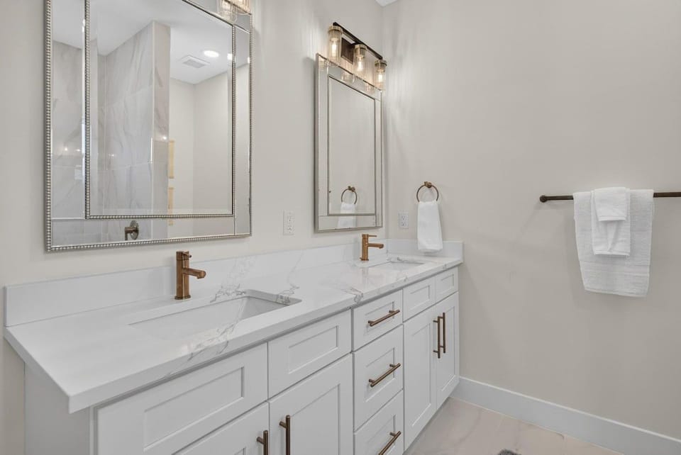 Get ready for a night out in style with this double vanity and marble countertop.