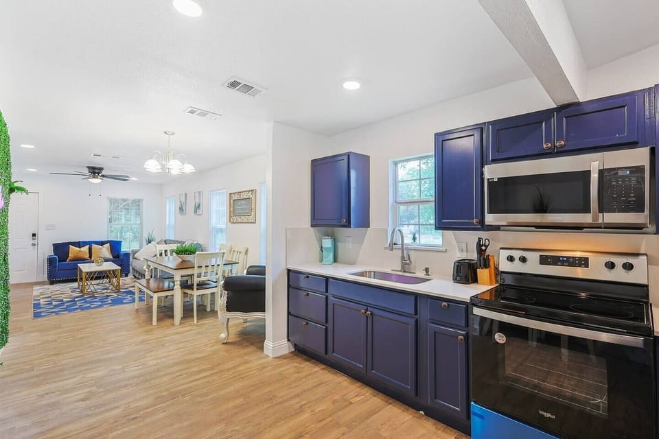 Fully equipped modern kitchen with blue cabinetry and essential appliances