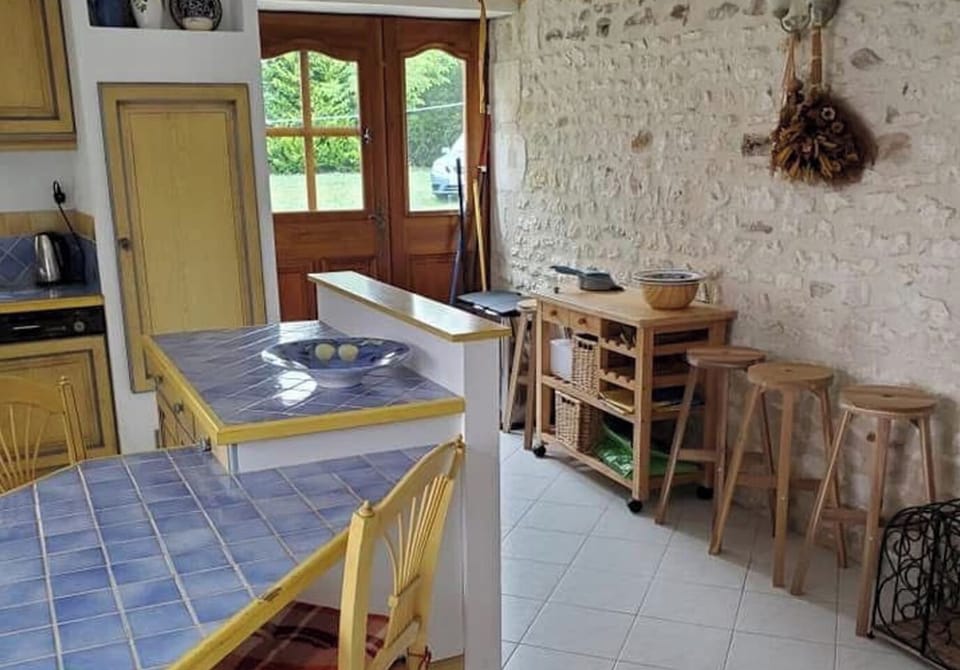 Country style kitchen with cooker, microwave, two fridge freezers , dishwasher