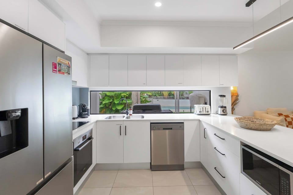 The fully equipped kitchen provides ample bench space, quality appliances, and everything you need to prepare anything from quick breakfasts to shared feasts.