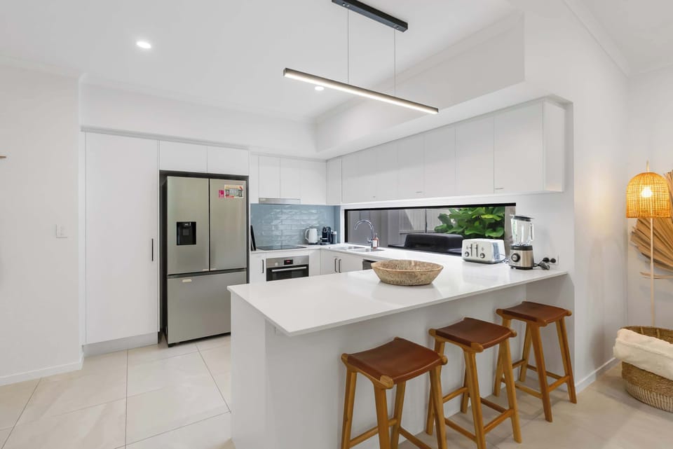 The spacious kitchen island with bar seating creates the perfect spot to enjoy breakfast, plan the day's adventures, or keep the cook company.