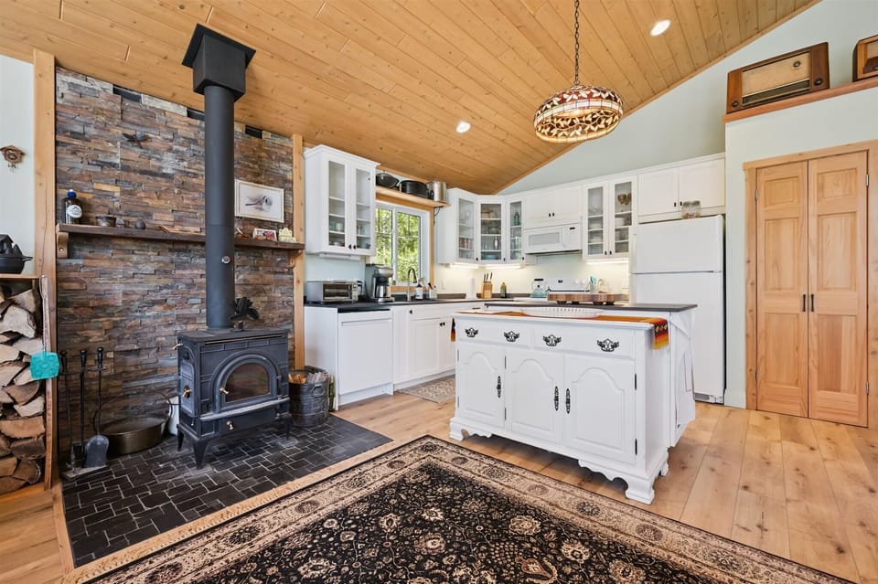 The bright, fully equipped kitchen is the heart of the cottage, blending modern convenience with warm cottage charm.