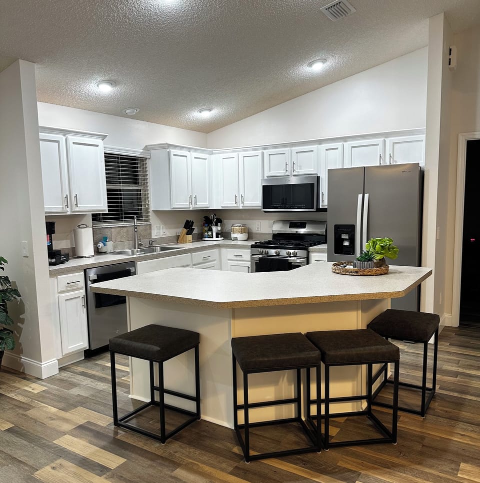 High-end appliances in kitchen, including gas stove or electric cooking top. 