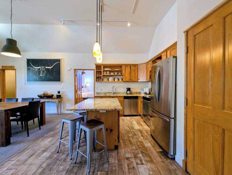 Your spacious kitchen features granite counters, stainless appliances, and a breakfast island where you can gather for morning coffee or prep meals together in this open space.