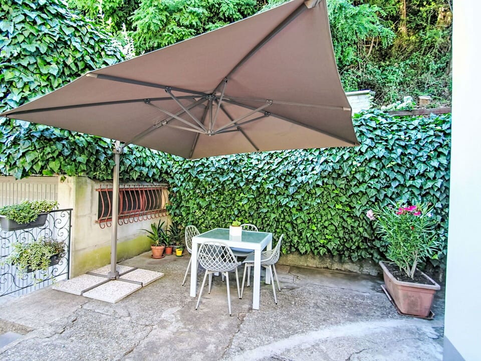 Umbrella, Furniture, Outdoor Furniture, Chair, Outdoor Table, Shade, Table, Patio, Outdoor Structure, Flowerpot