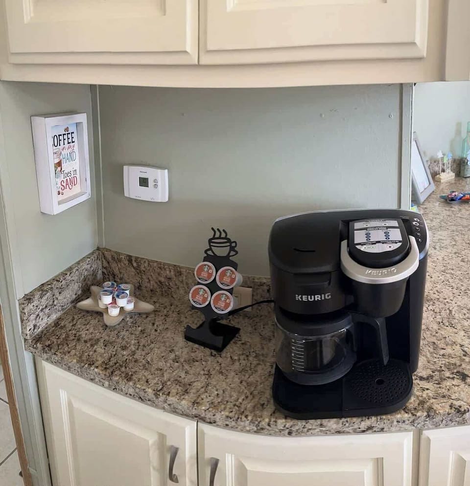 A convenient coffee station with a Keurig coffee machine and mugs to start your day right.