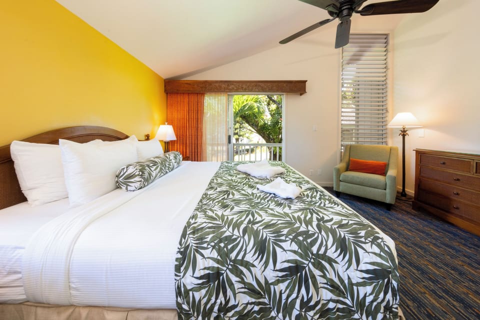 Unwind into crisp linens with lush balcony views.