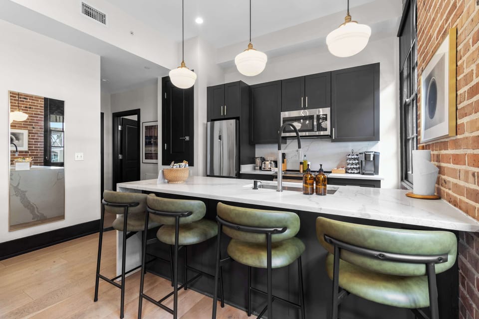 Cook or snack in style with a full kitchen featuring GE stainless appliances, cookware, and an island with bar seating. Ideal for short or extended stays, our kitchens make group travel in New Orleans easy and comfortable.
