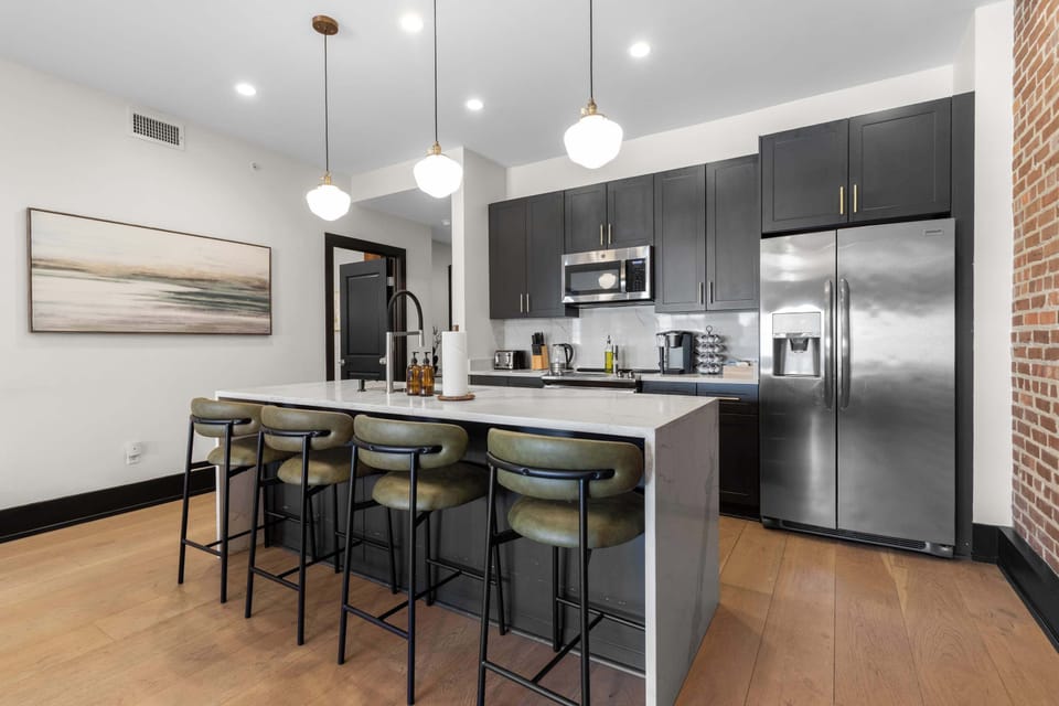 Cook or snack in style with a full kitchen featuring GE stainless appliances, cookware, and an island with bar seating. Ideal for short or extended stays, our kitchens make group travel in New Orleans easy and comfortable.