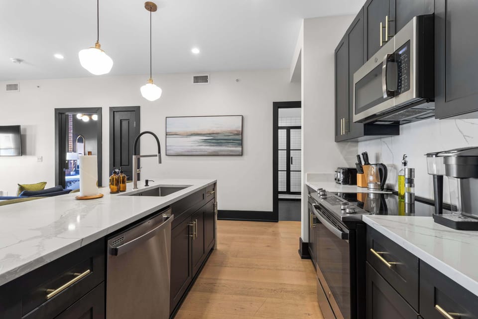 Cook or snack in style with a full kitchen featuring GE stainless appliances, cookware, and an island with bar seating. Ideal for short or extended stays, our kitchens make group travel in New Orleans easy and comfortable.