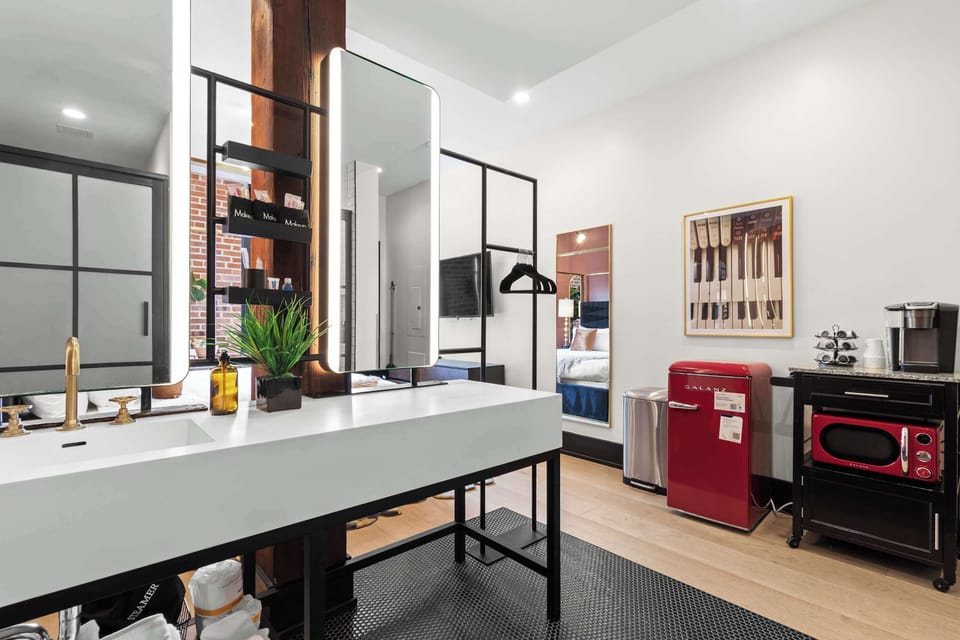Refresh in the spacious bathroom featuring a large walk-in shower, double vanity with illuminated mirrors, plush towels, and premium finishes designed for comfort and convenience.