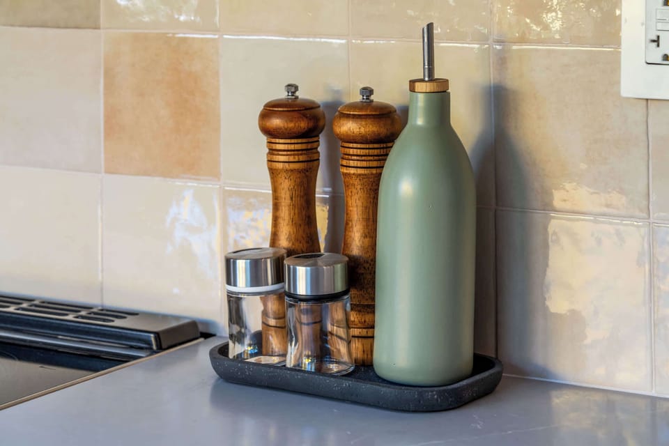 Salt, pepper and oil left stocked by the hob.