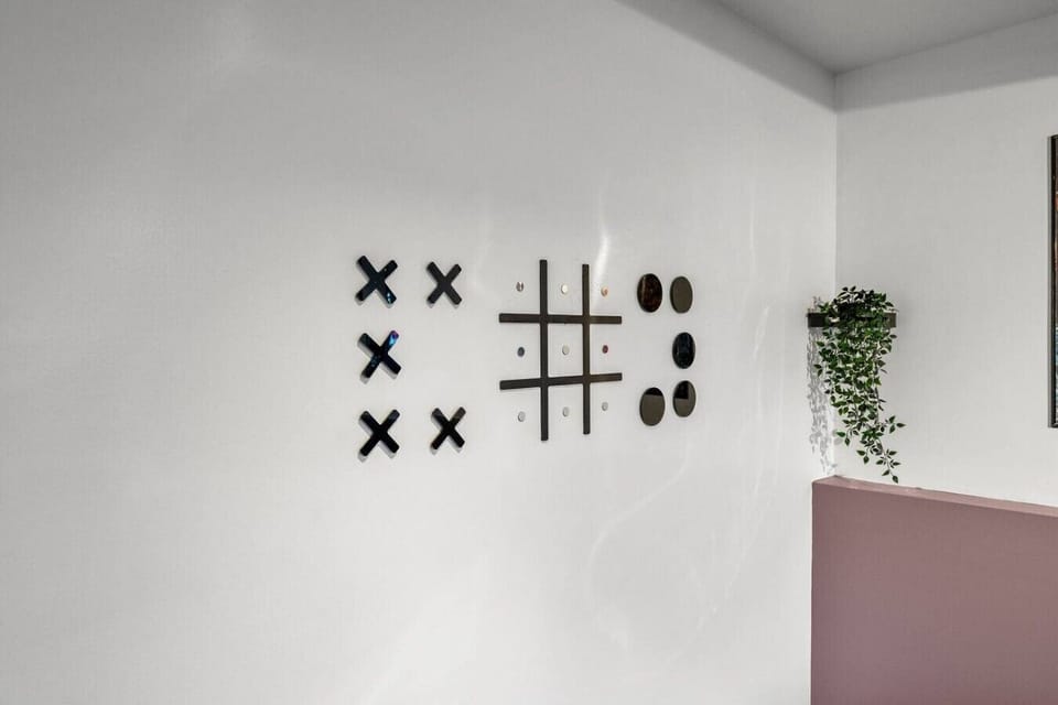 Contemporary living room featuring fun interactive wall art and potted plants