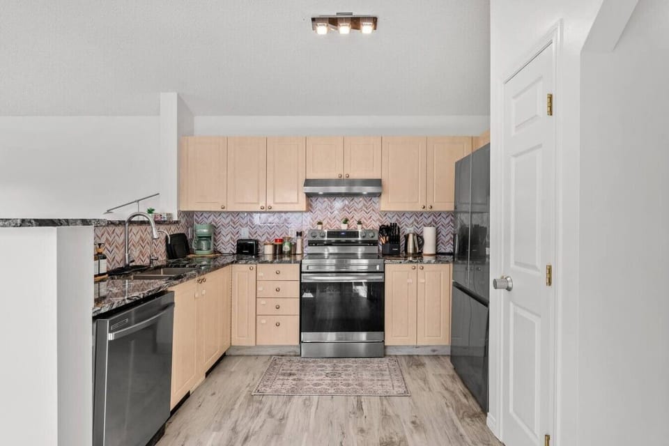 Complete kitchen with gas stove, refrigerator, and all necessary cooking equipment