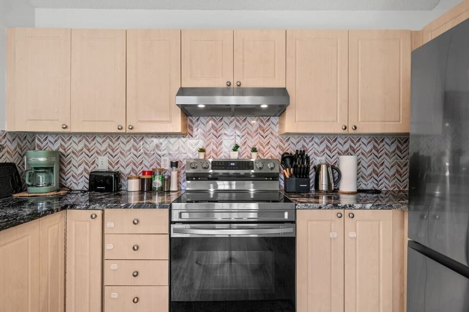Modern kitchen featuring stainless steel appliances and granite countertops