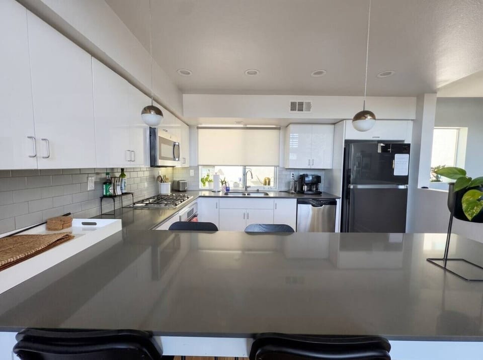 A spacious kitchen island makes this the perfect spot for morning coffee or casual meals together.