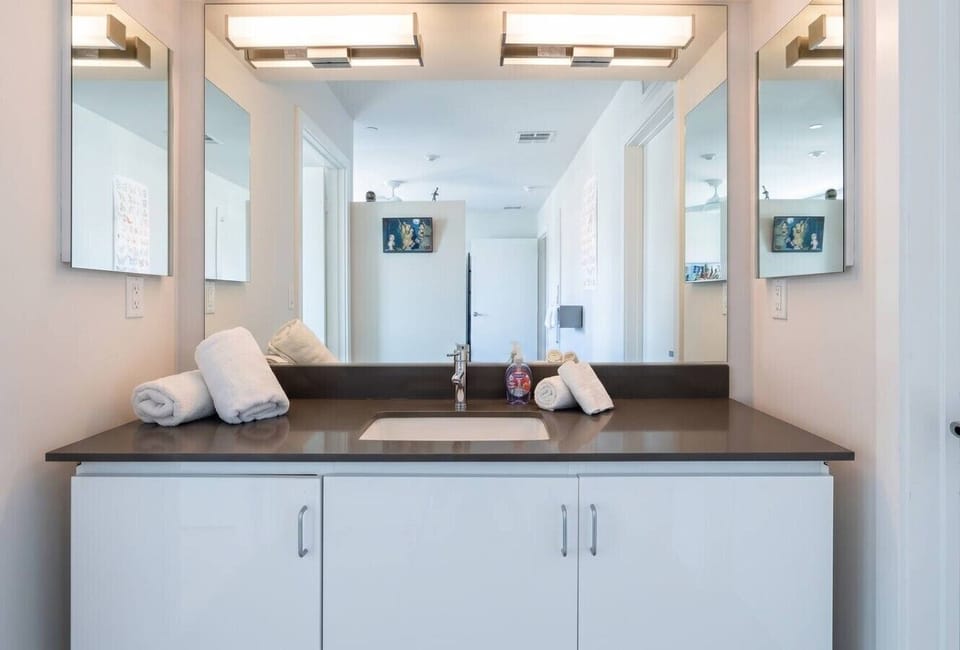 Plenty of counter space and thoughtful details in this bright, modern bathroom.
