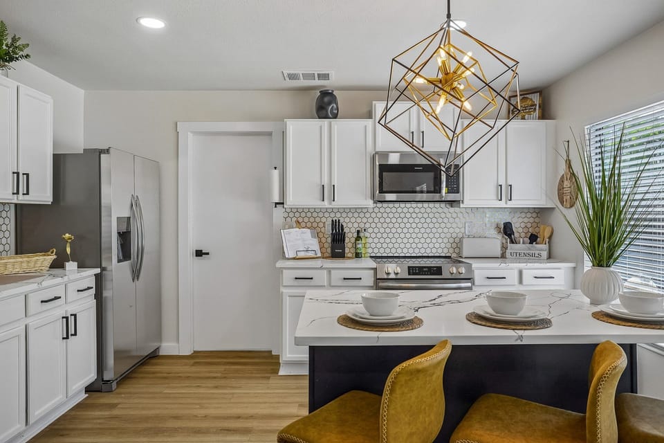 Bright modern kitchen with island seating and stylish designer lighting
