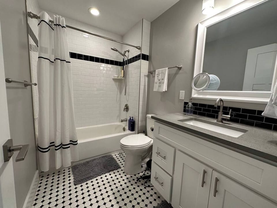 Stylish modern bathroom with tub, subway tile, and sleek vanity