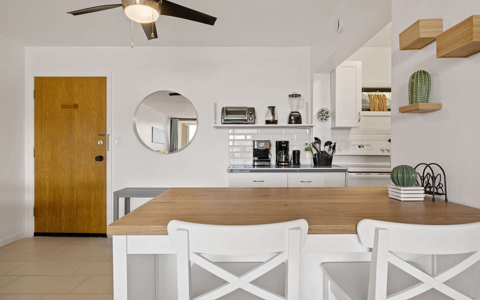 Coffee bar with a drip coffee maker, espresso maker, and a whole bean grinder.