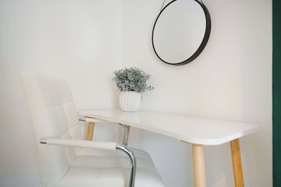 Enjoy a restful night's sleep in the upstairs bedroom with a comfortable double bed, Smart TV, bedside lighting, clothing storage, and a desk/dresser. Storage space also includes a vacuum cleaner and steps.
